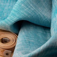 a roll of fabric sitting on top of a wooden table