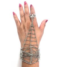 "Be your a Dreamweaver with this enchanting silver-tone spider web finger bracelet. A delicate and intricate spider web chain fits over one finger, then a detailed cuff securely clasps around the wrist. With a whimsical and intricate design, this spiderweb finger bracelet will embellish your festive style- it's Ideal for Halloween, but it can be worn year-round by nature lovers. This fun women's spider web bracelet makes a great addition to your jewelry collection- you'll love our spider finger Spider Web Chain, Crystal Spider, Spider Ring, Finger Bracelets, Back Of Hand, One Finger, Arm Jewelry, 1928 Jewelry, Hand Wrist