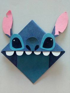 an origami monster head with two eyes and ears