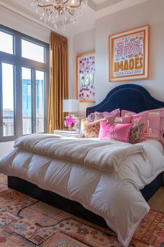 a bedroom with a bed, chandelier and large window overlooking the ocean in front of it