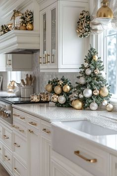 a christmas tree sitting on top of a kitchen counter next to a sink and oven