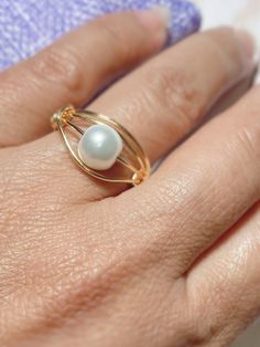 "Beautiful and Unique Gold Wire Wrapped Ring, ideal for an special gift for her,  This ring is made with a 3mm round pearl and wrapped in non tarnish gold wire. This ring is made to order in the size of your choice.  Available in tree different wire colors Gold, rose gold and silver, and you can choose the size and the color of the gemstone. I T E M ~D E T A I L S Materials: Gold Plated Wire, Pearls. Size: See Variations. You can also ask for a different wire color, silver or rose gold tone are Handmade Minimalist Pearl Ring For Wedding, Minimalist Handmade Pearl Wedding Ring, Elegant Hand Wrapped Rings For Anniversary, Elegant Adjustable Wire Wrapped Pearl Ring, Wire Wrapped Pearl Wedding Ring, Elegant Wire Wrapped Toe Rings, Minimalist Wire Wrapped Wedding Jewelry, Adjustable Pearl Drop Wedding Ring, Adjustable Pearl Drop Ring For Wedding