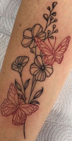 a tattoo with flowers and butterflies on it