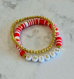 Fun and pretty bracelets perfect to wear on game day️ Red Team Spirit Bracelets For Gifts, Sporty Adjustable Beaded Jewelry, School Spirit White Jewelry As Gift, Adjustable Team Spirit Jewelry Gift, White School Spirit Jewelry As A Gift, White School Spirit Jewelry As Gift, Casual Personalized Jewelry For Game Day, Adjustable Team Spirit Stretch Bracelet For Game Day, School Spirit Jewelry With Letter Beads For Gifts