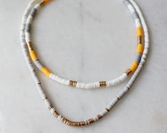 "more cute and fun necklaces and earrings in DearDanielleJewelry: https://www.etsy.com/shop/DearDanielleJewelry?ref=seller-platform-mcnav§ion_id=28417638 July4 necklace.multi heishi beads necklace. Surfer beads necklace. Summer beach necklace. Red white and blue rubber, polymer beads necklace Please pick your color: red and blue. pink and white. blue and green. Yellow and Grey adjustable necklace length: 16-18\" Bead size: 3/16\" diameter **framed gems and charms are gold plated which means you Vacation Beaded Necklaces With Colorful Heishi Beads, Multicolor Tiny Beads Necklaces For The Beach, Colorful Heishi Beads Necklace For Beach, Colorful Heishi Beads Beach Necklace, Hand-strung Heishi Beaded Necklaces For Beach, Rubber Bead, Polymer Beads, Beach Necklaces, Hippie Necklace