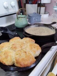 a skillet with some food on top of it next to a pot of soup