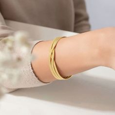 In a world of overcomplicated jewelry pieces, the Twisted Gold Bangle offers an air of effortless sophistication. High-end recycled gold is twisted artfully by Ecksand's masterful craftspeople to create an irresistible, eye-catching piece. Modern Twist Twisted Jewelry Gift, Elegant Metal Spiral Cuff Bracelet, Elegant Spiral Metal Cuff Bracelet, Modern Twist Yellow Gold Bracelet For Gift, Adjustable Modern Jewelry With Tarnish Resistance, Elegant Spiral Metal Jewelry, Adjustable Modern Twist Tarnish-resistant Jewelry, Adjustable Tarnish-resistant Modern Jewelry, Adjustable Spiral Gold Jewelry