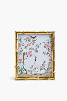 an ornately decorated frame with birds and flowers on it, against a white background