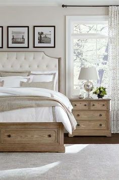 a bedroom with a bed, dressers and pictures on the wall above it's headboard