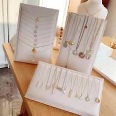 there are many necklaces on display in the store