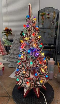 a wooden christmas tree with lights on it