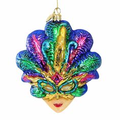 an ornament shaped like a woman's face with colorful hair and mask