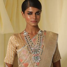 Description Radiate the energy of sparkle with Vajramaya - a statement neckpiece, handcrafted to make you shine bright on your big day. Falling in three layers, this gold plated silver chain is studded with cubic zirconia and enriched with stately green gemstones. The floral motifs in this jewelry design is intricate and intimate, just like a well-planned bridal trousseau. Product Information Materials used: 925 Silver with 1.0-microns Gold Plating Stones: Semi precious stones Length: 39 cm and Bridal Jewellry, Silver Long Necklace, Bridal Trousseau, Long Silver Necklace, Green Gemstones, Floral Motifs, Gold Plated Silver, Shine Bright, Floral Motif