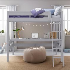 a bunk bed with a desk underneath it and a bean bag chair in front of it