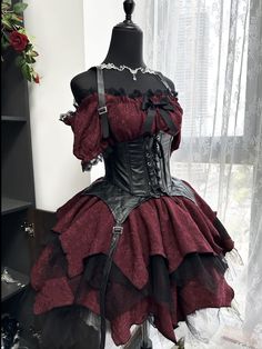 a mannequin is dressed in red and black with chains on the bustle