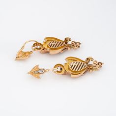 Elegant pair of antique Victorian earrings (circa 1860s to 1870s) crafted in 14k yellow gold.   Old rose cut diamond range in size from 0.01 to 0.30 carats and total an estimated 2 carats (estimated at L-M colour and I2-3 clarity). The charming day & night earrings can be worn as long 2 inch articulated drops, or shorter 3/4 inch drops. The top portion of the earrings are removable. The beautifully designed earrings are set with bright and lively old rose cut diamonds totaling an estimated 2 car Antique Drop Earrings With Historical Design, Antique Yellow Gold Wedding Earrings, Antique Yellow Gold Earrings For Wedding, Antique Wedding Earrings With Historical Design, Antique Earrings With Historical Design For Ceremonial Occasions, Vintage Gold Diamond Earrings With Rose Cut, Antique Yellow Gold Ceremonial Earrings, Vintage Gold Earrings With Rose Cut Diamonds, Victorian Hallmarked Earrings For Ceremonial Occasions