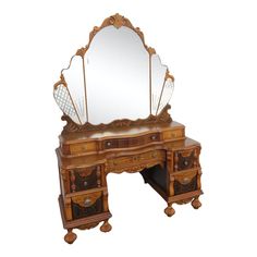 an antique wooden vanity with mirror on it's side and drawers underneath the mirror