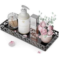 a tray that has some flowers and candles on it with soap, toothbrushes and lotion