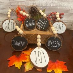 a wooden box filled with thanksgiving decorations on top of a brown table covered in leaves