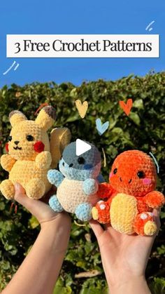 three crocheted stuffed animals are held up in front of some bushes with hearts