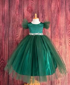 This beautiful elegant dress is one of my favorite! So modern and classy for any special occasion. Bodice is made of Hunter Green satin followed by fluffy Hunter Green tulle sleeves, waistline consists of a rhinestone band (not removable) a hidden zipper can be found in the back of the dress. The skirt consist of 2 Hunter Green Tulle layers, a layer of Hunter Green satin followed by lining with crinoline for fullness. Dress is pictured with Petticoat to show full detail. NOT INCLUDED https://www.etsy.com/listing/1305138635/white-petticoat-wedding-bridesmaids?click_key=c98dd4420cf3925879eead78fd2d73c6223871f5%3A1305138635&click_sum=37390cf8&ref=shop_home_active_3&crt=1 Visit our store, more items to come!  https://www.etsy.com/shop/LittledarlnBoutique?ref=profile_header CUSTOM MEASUREMENTS Fitted Tulle Holiday Dress For Fancy Occasions, Fitted Tulle Dress For Fancy Dress Holiday, Holiday Princess Ball Gown For Fancy Dress, Princess Ball Gown For Holiday Fancy Dress, Holiday Princess Dress Ball Gown For Dress-up, Fitted Princess Style Tulle Holiday Dress, Princess Style Green Ball Gown For Pageant, Elegant Christmas Princess Dress In Tulle, Elegant Christmas Tulle Princess Dress