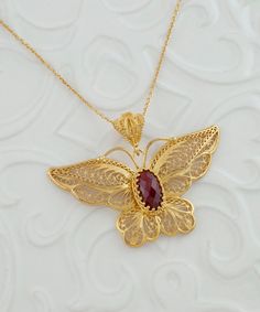 Gold Ruby Corundum Butterfly Silver Pendant Necklace, 925 Sterling Silver Gold Plated Artisan Handcrafted Filigree Pendant Handmade Necklace Necklace Monarch Butterfly, ornate butterfly, gold large necklace, one of a kind, vintage big pendant, victorian necklace Gemstone: Ruby Corundum 7x14mm. Material: 925K Sterling Silver ( 18K Gold Plated ). ( NICKEL FREE ) Chain Length:  -21 Inches ( 53 cm ) -18 Inches + 2 Inches Extender ( 46 cm + 5 cm Extender ) Pendant height and width: -2.35 Inch X 1.4 Inch // 6cm X 3.5cm  FREE, FAST AND TRACKABLE SHIPPING FOR ALL EU COUNTRIES AND USA. COMES WİTH VELVET POUCH AND LUXURY GİFT BOX. Made from our finest sterling silver with gold filled, this necklace is stunning and adds the perfect touch to any outfit. This necklace adds a touch of elegance while mak Big Pendant Design, Carved Yellow Gold Necklace Perfect For Gift, Gold Ruby Jewelry With Filigree Detail, Carved Yellow Gold Necklace, Carved Yellow Gold Necklace For Gift, Exquisite Filigree Pendant Jewelry, Carved Pendant Necklace For Wedding, Red Filigree Pendant Jewelry, Artisan Filigree Pendant Jewelry