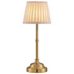 a gold lamp with a white shade on it