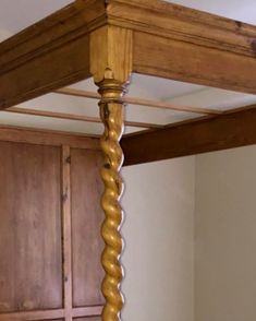 a wooden bed frame with gold colored spirals on it