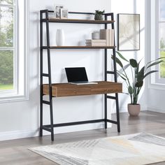 a laptop computer sitting on top of a wooden shelf next to a plant and window