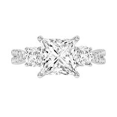 a princess cut diamond ring with three side stones