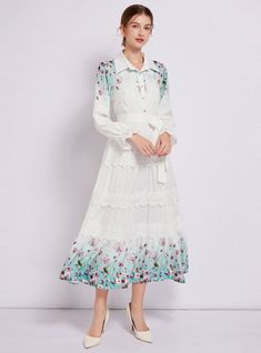 Captivating and ethereal, this enchanting long-sleeved dress is a portrait of bucolic elegance. Its fitted bodice descends into a gently tiered skirt, creating a silhouette that’s both classic and whimsical. The crisp white fabric serves as a canvas for delicate floral patterns that bloom across the hem, lending a touch of springtime regardless of the season. Lace trims add a sophisticated touch, framing the neckline and cuffs with exquisite detail. With a cinched waist accentuated by a self-tie belt, this dress shapes a figure that is both graceful and poised. It’s a versatile piece that transitions seamlessly from a countryside stroll to a chic urban evening. Fabric name: polyester fiberPattern: printingSkirt length: long skirtSkirt type: large swing typeSleeve length: long sleevesColor: White Long Sleeve Dress With Ruffles For Summer, Spring Fitted Long Sleeve Dress With Ruffle Hem, Fitted Long Sleeve Dress With Ruffle Hem For Spring, Spring Long Sleeve Dress With Ruffles, White Long Sleeve Ruffled Dress For Fall, Spring Dress With Lace Trim And Tiered Skirt, Long Sleeve Midi Dress With Ruffle Hem For Daywear, Long Sleeve Dresses With Lace Trim For Garden Party, White Long Sleeve Maxi Dress With Ruffle Hem