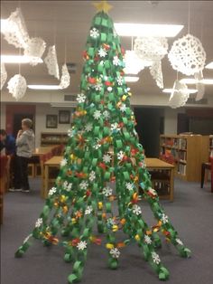 a christmas tree made out of plastic bottles in the middle of an office cubicle