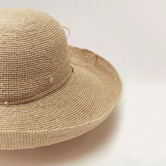 The Provence is a hallmark Helen Kaminski hat with a 12cm brim that can be styled up or down. Featuring a hand rolled raffia tie for adjustable sizing and a neoprene band for comfort, this style rolls to pack making it a perfect travel accessory. With over 14,000 stitches of sustainably harvested Madagascan raffia and taking over three days to complete, the Provence displays the true art form of artisanal handcraft with subtle variations being unique to each hat. We source the finest, sustainably harvested Madagascan raffia that is hand selected, washed or dyed and seamlessly crocheted with no visible seams, knots or joins. Raffia has a natural resin making it innately soft, supple and resilient; Unlike straw, raffia has longevity and won't crack or get brittle over time. Applying light st Elegant Adjustable Toquilla Straw Hat, Chic Adjustable Hats For Kentucky Derby, Adjustable Natural Boater Hat With Short Brim, Elegant Adjustable Woven Hat Bands, Elegant Adjustable Woven Boater Hat, Chic Adjustable Cloche Hat For Kentucky Derby, Chic Adjustable Flat Brim Panama Hat, Chic Adjustable Woven Sun Hat, Adjustable Woven Cloche Hat With Curved Brim