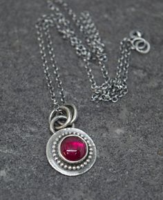 International deliveries in 2-4 business days as standard shipping. Totally handmade from 925 solid sterling silver. Beautiful necklace with an 8 mm Lab created ruby bezel set in sterling silver. The necklace goes with a 40 cm polo silver chain. A synthetic gem material is one that is made in a laboratory, but which shares virtually all chemical, optical, and physical characteristics of its natural mineral counterpart. It comes gift wrapped and ready for giving! ✿REGISTERED MAIL WITH TRACKING NU Handmade Pendant Birthstone Necklace In Sterling Silver, Handmade Sterling Silver Pendant Birthstone Necklace, Ruby Round Pendant Necklace, Silver Round Pendant Birthstone Necklace, Silver Pendant Birthstone Necklace With Bezel Setting, Silver Sterling Silver Birthstone Necklace With Round Stone, Silver Birthstone Pendant Necklace With Bezel Setting, Sterling Silver Round Birthstone Necklace, Silver Birthstone Necklace With Round Pendant