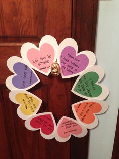 a wreath made out of paper hearts with words written on them