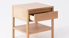 a small wooden table with one drawer open