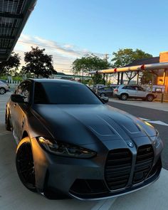 a black car parked in front of a gas station