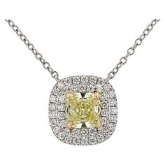 A signed Tiffany & Co. natural Yellow Diamond pendant necklace, from the legacy jewelers' Soleste Collection. The center diamond, a Fancy Yellow color shines with modified facets providing extra sparkle. The near 3/4 carat center diamond is set in 18k yellow gold prongs and surrounded with a double halo of 43 near colorless accent diamonds, expertly crafted in enduring platinum with authentic Tiffany hallmarks.   Condition: Excellent Era: Contemporary Year: 2016 Metal: 18k Yellow Gold & Platinum Tiffany Yellow Diamond Necklace, Luxury Yellow Diamond Cut Necklace, Luxury Yellow Necklace With Brilliant Cut, Luxury Yellow Necklaces With Diamond Accents, Yellow Diamond Pendant, Elegant Yellow Diamond-cut Necklace, Chanel Pendant, Purple Pendant Necklace, Art Deco Pendant Necklace