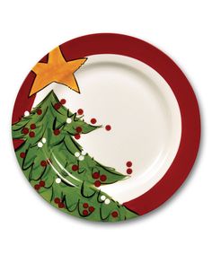 a plate with a christmas tree painted on the front and bottom, along with a red border