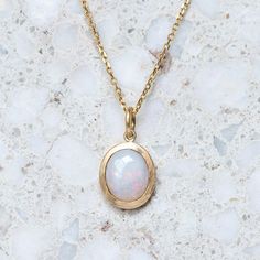 A milky crystal opal has been set into our classic matte gold bezel. Opal measures 10 x 8 mm oval. Weight without chain 2.5g approx. Trace chain measures 45cm. Pictured with a matte finish. For a high shine finish, please leave a note at checkout. Please note, we will match the opal as close to the image as possible. Each opal is unique and may vary in appearance and colour from what is depicted on the site.