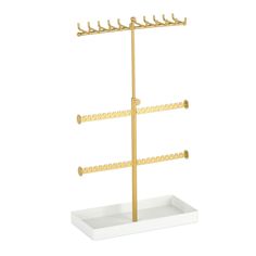 a gold and white rack with three hooks