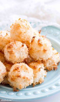 a blue plate topped with coconut macaroni and cheese bites on top of a white table cloth