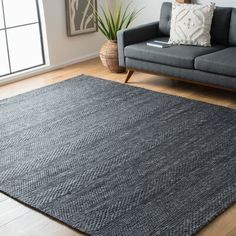 a living room with a couch, chair and rug