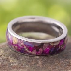 Get this flower ring for the blossoming beauty in your life. Flowers play a supporting roll in many different occasions from graduations to funerals, and of course weddings. Celebrate the magnificence of these delicate beauties with this flower wedding band. Your ring can be made with petals from our collection, or you can supply your own dried flowers for use in your custom ring.RING LAYOUT Ring Width: 6 mm Ring Sleeve: Titanium Ring Profile: Round Ring Finish: Polished0.5 mm Titanium 5 mm Flow Tension Set Engagement Rings, Flower Wedding Band, Red Earrings Stud, Rose Gold Morganite, Titanium Wedding Band, Titanium Ring, Vintage Wedding Band, Plain Bands, Morganite Engagement