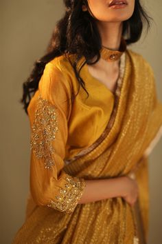 Ochre semi-stitched saree blouse with embroidered sleeves.
Components:1
Embroidered
Sleeve Length:Three quarter
Fabric:Chanderi 
Color:Yellow
Note: Saree worn by the model is not for sale - Aza Fashions Saree Blouses Online, Women Saree, Indian Saree Blouse, Indian Saree Blouses Designs, Gold Blouse, Saree Blouses, Designer Outfits, Indian Clothing, Blouse For Women