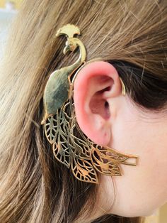 This peacock brass ear cuff is a part of our collection of tribal jewellery. Our tribal ear cuffs are versatile and can be worn with both traditional and contemporary outfits.  They add a touch of glamour and elegance to any look and are a popular choice for special occasions such as weddings, festivals, and cultural events. Sold single, please select quantity x2 for a pair. The size is shown on picture. Ear cuffs do not pull the ear lobe down no matter how elaborate their design is so no need t Bohemian Gold Brass Body Jewelry, Unique Metal Body Jewelry For Festivals, Gold Brass Single Ear Cuff Earring, Handmade Bohemian Gold Body Jewelry, Handmade Silver Brass Body Jewelry, Gold Brass Single Ear Cuff, Handmade Gold Bohemian Body Jewelry, Bohemian Brass Body Jewelry For Festivals, Single Gold Brass Ear Cuff