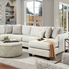 a living room filled with furniture and a fire place next to a large open window