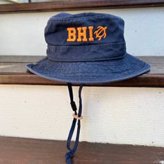 Sun protection meets fun and style with our BHI Embroidered Monogram UPF Boonie Youth Bucket Hat. This cool hat for kids features soft yet durable garment-washed-twill fabric for easy-wearing comfort and durability. A mesh lining promotes faster drying and cooling breathability. The boonie style gives all-around coverage with UPF 50 sun protection to shield against harsh rays. A breakaway chin cord feels comfy while keeping the hat in place. Cotton Durable & ideal for wear in the great outdoors Red Brimmed Bucket Hat For Outdoor, Summer Adjustable Embroidered Bucket Hat, Brimmed Bucket Hat With Uv Protection For Fishing, Wide Brim Bucket Hat With Upf 50+ For Fishing, Adjustable Upf 50+ Bucket Hat For Fishing, Cool Hat, Turtle Time, Hat For Kids, Navy And Khaki