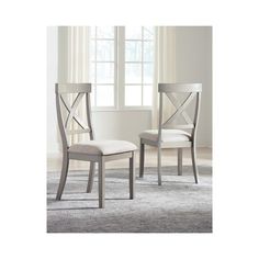 a pair of chairs sitting on top of a carpeted floor next to a window