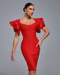 a woman in a red dress posing for the camera with her hands on her hips